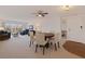 Bright living room with dining area and neutral carpet leading to the balcony overlooking an attractive neighborhood at 1120 N Shore Ne Dr # 503, St Petersburg, FL 33701