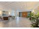 View of the building's elegant lobby with tile flooring, modern seating, and elevator access at 1120 N Shore Ne Dr # 503, St Petersburg, FL 33701