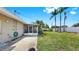 Spacious backyard with lush green lawn and a tropical foliage view at 11460 Park Blvd, Seminole, FL 33772
