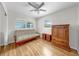 Bedroom with hardwood floors, ceiling fan, lots of natural light, and matching wood furniture at 11460 Park Blvd, Seminole, FL 33772