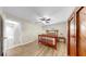 Bedroom featuring hardwood floors, ceiling fan, and an ensuite bathroom at 11460 Park Blvd, Seminole, FL 33772