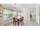Well-lit dining area features chandelier, window with blinds, tile flooring and natural lighting at 11460 Park Blvd, Seminole, FL 33772