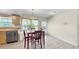Dining area features view to outside, and a chandelier, with tile flooring and beige walls at 11460 Park Blvd, Seminole, FL 33772