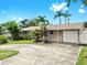 Charming single-story home with well-maintained lawn, mature palms, and a spacious driveway at 11460 Park Blvd, Seminole, FL 33772