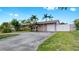 Inviting single-story home showcasing a one-car garage, well-maintained lawn, and white privacy fence at 11460 Park Blvd, Seminole, FL 33772