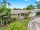 Inviting single-story home with lush landscaping, mature trees, and a well-manicured lawn at 11460 Park Blvd, Seminole, FL 33772