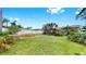 Lush green front yard with tropical foliage and mature shade trees at 11460 Park Blvd, Seminole, FL 33772