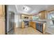 Bright kitchen with stainless steel appliances, tile flooring, wood cabinets, and ample counter space at 11460 Park Blvd, Seminole, FL 33772