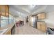 Open floorplan displays kitchen with stainless refrigerator adjacent to dining area with chandelier at 11460 Park Blvd, Seminole, FL 33772
