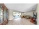 Living room with tile flooring, ceiling fan, sliding glass doors, and large china cabinet at 11460 Park Blvd, Seminole, FL 33772