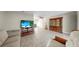 Open concept living room features tile flooring, ceiling fan and seamless flow at 11460 Park Blvd, Seminole, FL 33772