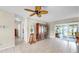 Spacious living room with tile flooring, sliding glass doors to lanai, and neutral color palette at 11460 Park Blvd, Seminole, FL 33772