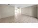 Bright, empty living room with tile floors, a ceiling fan, and neutral-colored walls at 11460 Park Blvd, Seminole, FL 33772