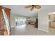 Open concept living room featuring sliding glass doors, ceiling fan and neutral decor at 11460 Park Blvd, Seminole, FL 33772