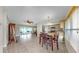 Open-concept living space with tile flooring, kitchen access, dining area, and lanai at 11460 Park Blvd, Seminole, FL 33772