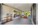 Covered patio featuring a planter and furniture, perfect for outdoor relaxation with views of the yard at 11460 Park Blvd, Seminole, FL 33772