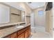 A bathroom has a granite vanity and shower with curtain at 1209 E Cumberland Ave # 2703, Tampa, FL 33602