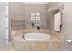 A luxurious bathroom features a tiled whirlpool tub and towel rack at 1209 E Cumberland Ave # 2703, Tampa, FL 33602