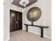 Elegant foyer with a large round mirror, accent table and ceramic flooring at 1209 E Cumberland Ave # 2703, Tampa, FL 33602
