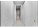 Bright hallway with white doors lead to a bathroom at 1209 E Cumberland Ave # 2703, Tampa, FL 33602