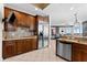 Open-concept kitchen with stainless steel appliances, granite countertops and wood cabinetry at 1209 E Cumberland Ave # 2703, Tampa, FL 33602