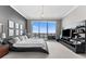 Modern main bedroom showcasing a platform bed, sleek decor, and expansive windows with scenic city views at 1209 E Cumberland Ave # 2703, Tampa, FL 33602