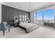 Sleek main bedroom featuring a platform bed, chic decor, and scenic balcony views at 1209 E Cumberland Ave # 2703, Tampa, FL 33602