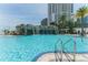 Inviting pool area with a rock waterfall, framed by palm trees, perfect for condo residents at 1209 E Cumberland Ave # 2703, Tampa, FL 33602