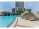Gorgeous community pool with rock waterfall feature, palm trees and adjacent to the condo buildings at 1209 E Cumberland Ave # 2703, Tampa, FL 33602
