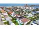 Aerial view featuring a tranquil residential neighborhood, showcasing lush landscaping, sparkling pools, and nearby beach access at 131 Forest Hills Dr, Redington Shores, FL 33708