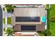 Aerial view of the property's roof with solar panels and a private backyard pool at 131 Forest Hills Dr, Redington Shores, FL 33708