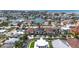 Great location! Aerial view of waterfront homes, mature palm trees, and a scenic canal neighborhood near the beach at 131 Forest Hills Dr, Redington Shores, FL 33708