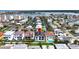 Aerial view of a two-story home featuring a solar roof and in-ground pool at 131 Forest Hills Dr, Redington Shores, FL 33708