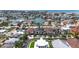 Stunning aerial view of waterfront homes, mature palm trees, and a scenic canal neighborhood near the beach at 131 Forest Hills Dr, Redington Shores, FL 33708