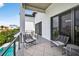 Relaxing balcony with comfortable seating, offering views of the pool and neighborhood at 131 Forest Hills Dr, Redington Shores, FL 33708