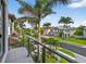 Balcony view overlooking the tree-lined street and beautiful homes in the neighborhood at 131 Forest Hills Dr, Redington Shores, FL 33708