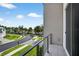 Balcony view showcasing the manicured lawns and tree lined street within the neighborhood at 131 Forest Hills Dr, Redington Shores, FL 33708