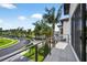 Balcony view showcasing the manicured lawns and tree lined street within the neighborhood at 131 Forest Hills Dr, Redington Shores, FL 33708