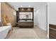 Elegant bathroom featuring a double vanity, a soaking tub, and stylish tile at 131 Forest Hills Dr, Redington Shores, FL 33708