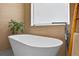 Modern bathroom featuring a freestanding tub, sleek fixtures, and stylish tile accents at 131 Forest Hills Dr, Redington Shores, FL 33708