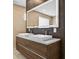Elegant bathroom with a double vanity, modern faucets, and a large illuminated mirror at 131 Forest Hills Dr, Redington Shores, FL 33708