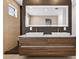 Elegant bathroom featuring a double vanity with modern faucets and a large, bright mirror at 131 Forest Hills Dr, Redington Shores, FL 33708