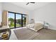 Bright bedroom featuring a large window with natural light and a neutral color palette at 131 Forest Hills Dr, Redington Shores, FL 33708