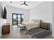 Bright bedroom with a gray bed, a dark blue rug, and a sliding glass door at 131 Forest Hills Dr, Redington Shores, FL 33708