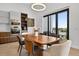 Bright dining area featuring modern appliances, stylish table, and seamless access to the outdoor balcony at 131 Forest Hills Dr, Redington Shores, FL 33708