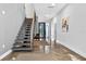 Contemporary entryway with floating stairs, high ceilings, and polished floors leading to a bright living space at 131 Forest Hills Dr, Redington Shores, FL 33708
