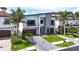 Stunning two-story home with a well-manicured lawn, brick driveway, and two-car garage at 131 Forest Hills Dr, Redington Shores, FL 33708