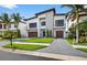 Modern two-story home boasts a manicured lawn, contemporary design, and a welcoming front entrance at 131 Forest Hills Dr, Redington Shores, FL 33708