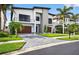 Striking two-story home with modern architecture, a well-maintained yard, and a charming curb appeal at 131 Forest Hills Dr, Redington Shores, FL 33708