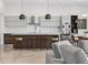 Sleek kitchen with a large island, modern lighting, and stainless steel appliances in an open layout at 131 Forest Hills Dr, Redington Shores, FL 33708